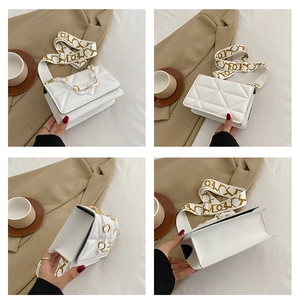 Detail view of white quilted crossbody bag with golden chain and patterned strap