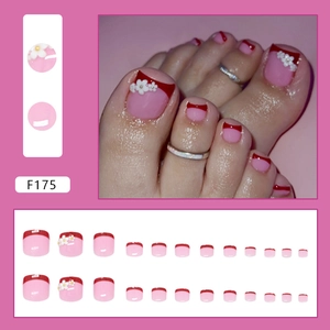 French tip floral press-on toenails with 3D white daisy designs on a pink base