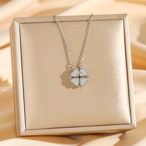 Silver four-leaf clover heart necklace with white zircons on champagne silk