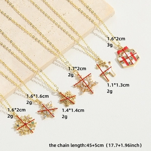 Golden Christmas necklaces featuring snowflake, reindeer and gift box charms on stone
