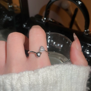 Detail shot of a silver double-heart open ring featuring zircon pave and mirror finish