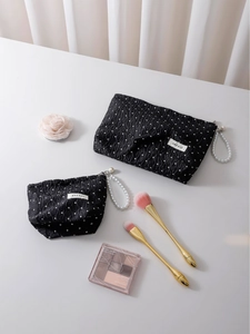 Black polka dot makeup bags with textured fabric and elegant pearl handle zipper