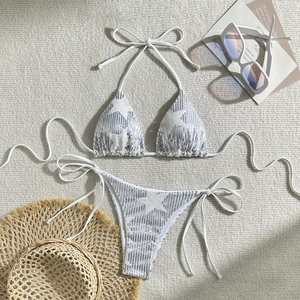 Sexy white sequin bikini set with star patterns and summer vacation props flat lay