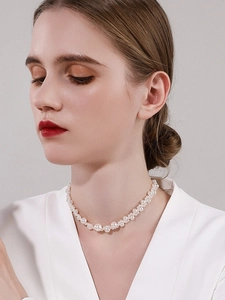Elegant woven pearl choker necklace worn by a model with a minimalist vintage aesthetic