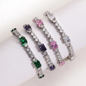 Detail of emerald cut zircon bracelets in green, purple, pink and white on a display