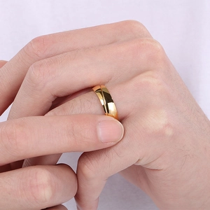Detailed view of polished 18K gold plated minimalist ring on index finger with smooth facets