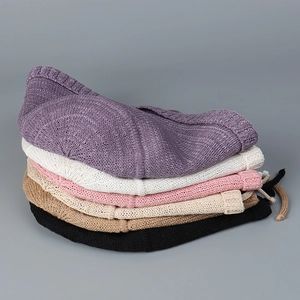 Stack of five colorful breathable knitted sun hats showing texture in various colors