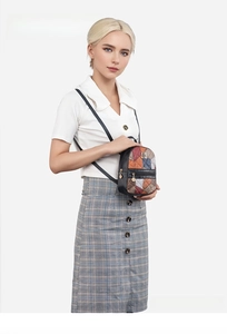 Fashionable small backpack featuring colorful geometric quilting and leather trim details
