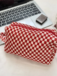 Red and white checkered velvet makeup bag with top handle and secure zipper closure