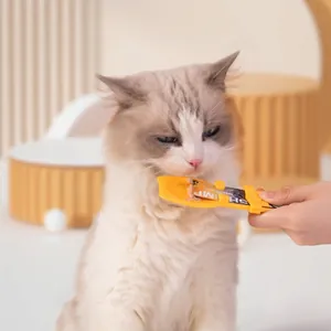 Bright yellow pet cat treat squeezer spoon for feeding liquid snacks to fluffy cats