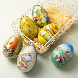 Colorful Easter egg tin boxes with bunny and chick patterns in a gift basket