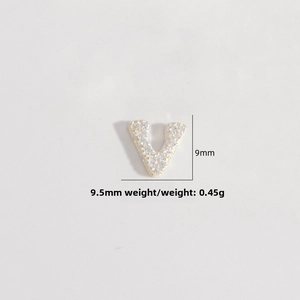 Detail of gold letter V pendant with micro-paved zircons measuring 9.5mm x 9mm
