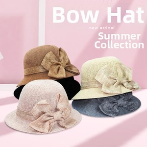 Close-up of wide brim straw sun hats featuring elegant bow knots in five colors