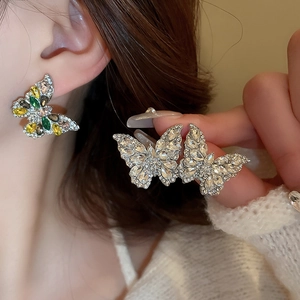 Close-up of sparkling butterfly drop earrings featuring vibrant rhinestones and silver pins
