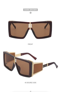 Detail of dark brown steampunk sunglasses with golden metal engraving and square frame