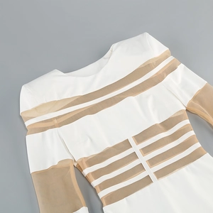Detailed view of mesh patchwork and horizontal stripes on white long sleeve dress