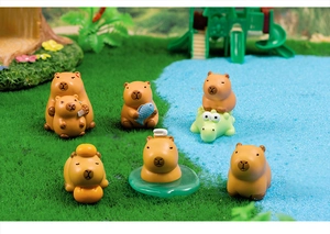 Detailed view of six mini resin capybara figurines in various cute poses on grass