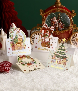 Detailed view of four gold-stamped Christmas cards with festive holiday decorations