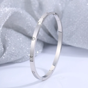 Polished titanium steel heart bangle with cubic zirconia crystals in silver tone