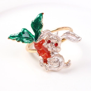 Silver rabbit napkin ring with red enamel carrot and rhinestone eyes on white background