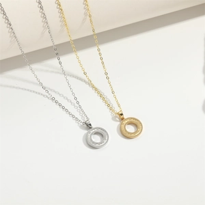 Detail of round honeycomb textured necklaces in gold and silver finish on white backdrop