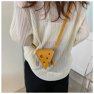 Detail view of a yellow cheese-shaped crossbody bag with adjustable strap and PU leather