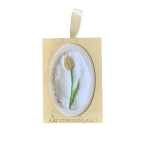 Coral fleece gift towel with yellow tulip embroidery in a beige window box with ribbon