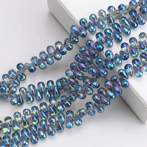 Macro view of blue teardrop iridescent glass crystal beads for DIY jewelry making