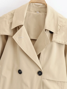 Close-up of khaki trench coat details featuring classic lapels and double-breasted buttons
