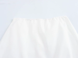 Close-up of white elastic waistband featuring soft fabric and palm tree embroidery