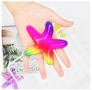 Detail of a colorful starfish hair clip with gradient pink and yellow texture in hand