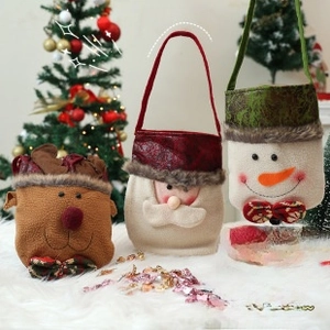 Detail of Christmas gift bags featuring reindeer and Santa designs with fur trim