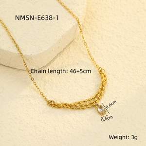 Detailed close-up of golden stainless steel necklace with a single crystal pendant on stone