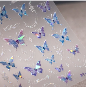 Macro detail of 3D laser butterfly nail stickers with purple gradient and lunar accents