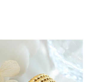 Macro close-up of woven 18K gold-plated titanium ring texture on white background