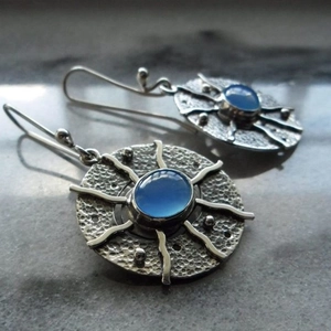 Vintage bohemian sun-shaped drop earrings with blue crystal stone and hammered silver disc