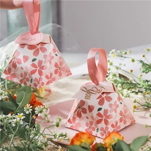 Pink cherry blossom pyramid candy boxes with satin ribbons and thank you tags for weddings