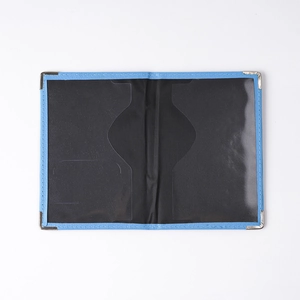 Detail view of blue PU leather passport cover with metal corners and black interior layout