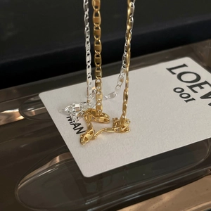 Detailed view of the interlocking gold and silver chain links with a metallic luster finish