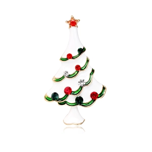 Christmas tree brooch with white enamel, rhinestones and gold plating on white background