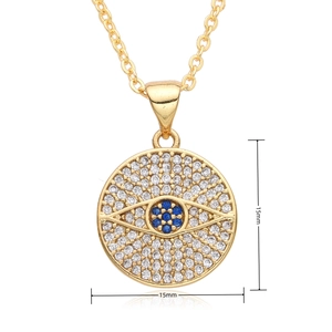 Macro view of a 15mm evil eye pendant with gold plating and pavé cubic zirconia
