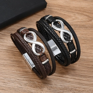Multilayer leather bracelet with silver infinity symbol on a rustic wood background
