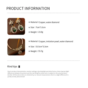 Detailed specs of vintage leaf necklace and earrings set with pearls and rhinestones
