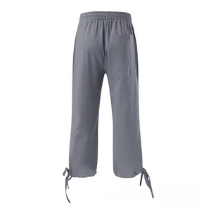 Detail view of cotton linen trousers featuring elastic waist, back pocket and drawstring hem