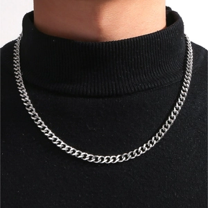 Polished silver Cuban link chain necklace worn by a model on a black turtleneck sweater