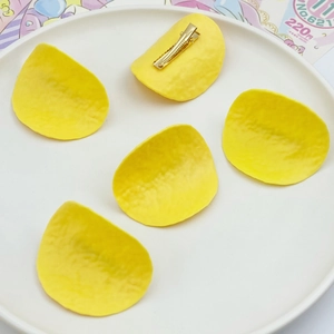 Detailed set of five yellow crinkle-cut potato chip hair clips with metal duckbill clips