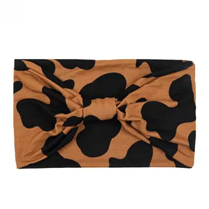 Close-up of brown leopard print elastic yoga headband with a knotted bow design