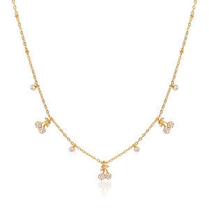 Detailed view of gold cherry pendant necklace with pavé zircons and crystal accents