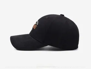 Detail view of the yellow FUTURE embroidery on this black cotton twill baseball cap