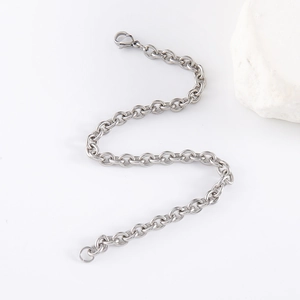 Polished silver stainless steel O-chain bracelet with lobster clasp on white background